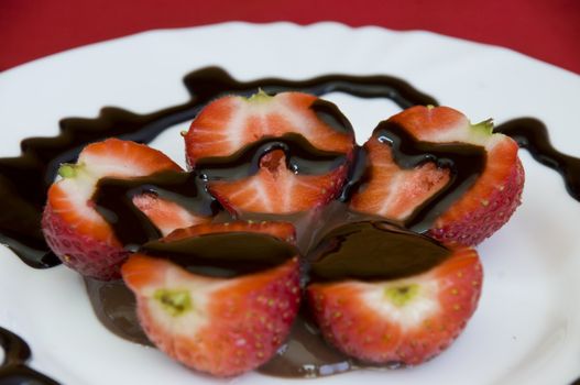 lovely arrangement of strawberries in chocolate, red background
