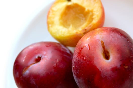 closeup of three ripe plums