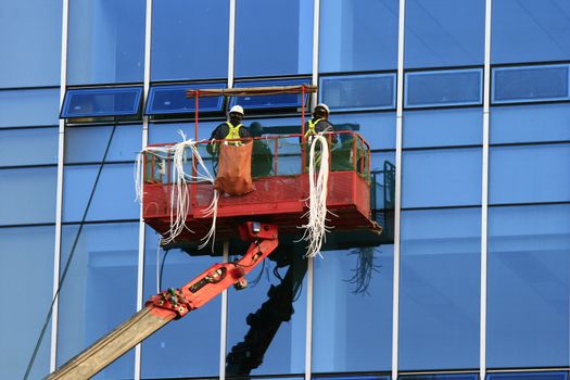 Construction Worker in Gondola with safety wear concept