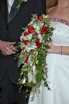 A bride and groom with the brides flowers