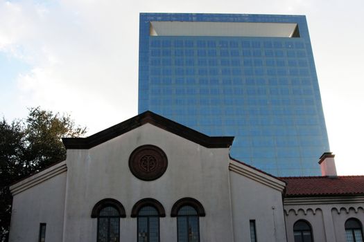 A old 1800 church with a modern skyscraper in the background