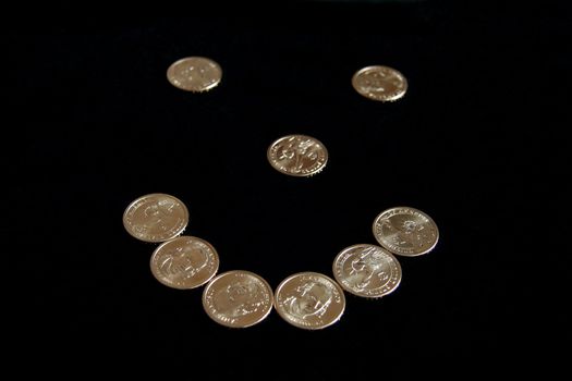 A smiley face made out of dollar coins