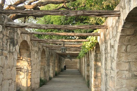 A timber lined colonnade at the Alamo in San Antonio Texas