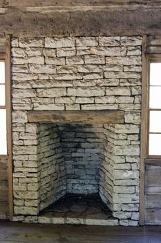 An old log cabin fireplace made out of stone