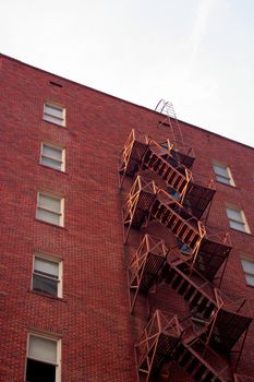 A fire escape going down the side of a brick building