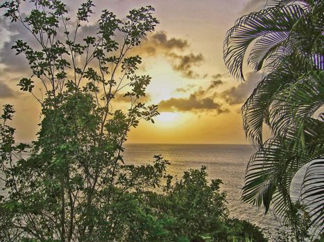 A tropical sunset that is over looking the ocean