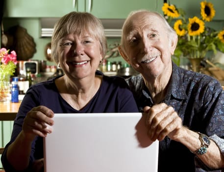 Senior Couple in their Dining Room with a Laptop Computer