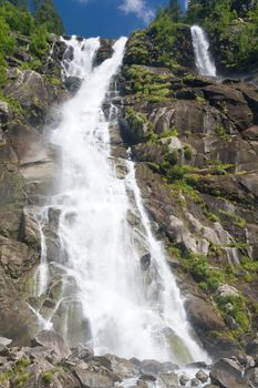 beautiful alpine waterfall in Val di Genova, Trentino, Italy