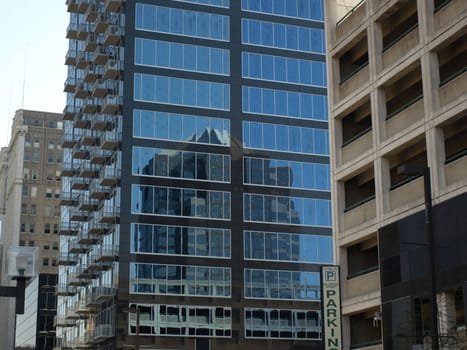 A glass building in downtown Greensboro,North Carolina. Notice the reflection on the glass.