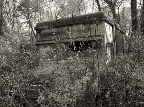 An old abandonded truck shown in black and white