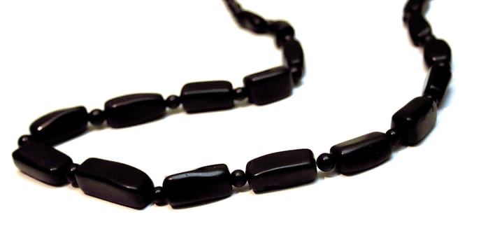 Black beads on a white background. Isolation. Shallow DOF