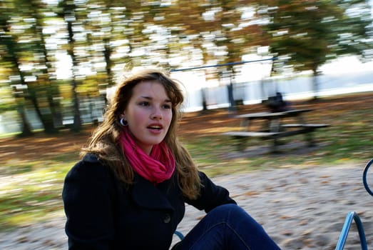 Teenage girl with spinning blurry background.