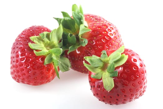 Close up of three strawberries isolated on white.