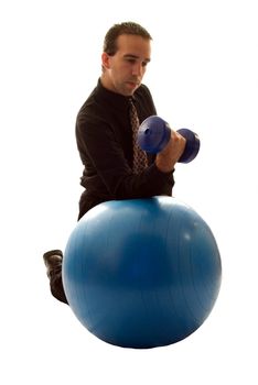 Businessman using a yoga ball and weights to help relieve stress