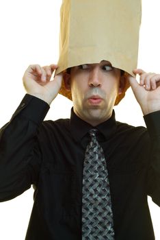 A young businessman hiding his head in a paper bag