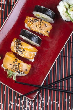 A complete sushi meal with chopsticks on tatami mat