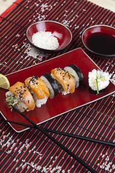 A complete sushi meal with chopsticks on tatami mat