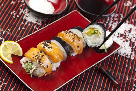 A complete sushi meal with chopsticks on tatami mat