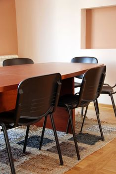 brown office meeting desk and black chairs indoor