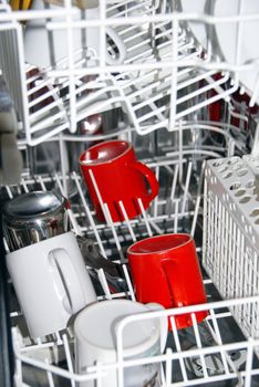 few white and red cups in dishwasher