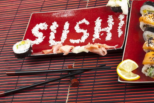 A complete sushi meal with chopsticks on tatami mat