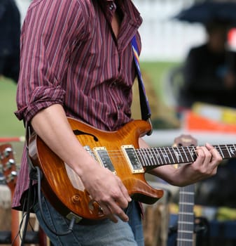 Musician playing electric guitar during an outdoor festival