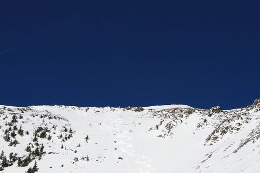 A freshly skied snow bowl on a beautiful day