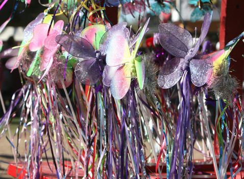 Butterfly wands for sale at a crafts booth. Very colorful and playful image.