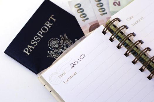 passport and notepad with world currency