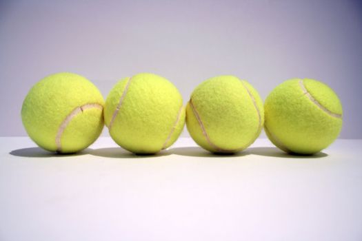 four tennis balls in line 