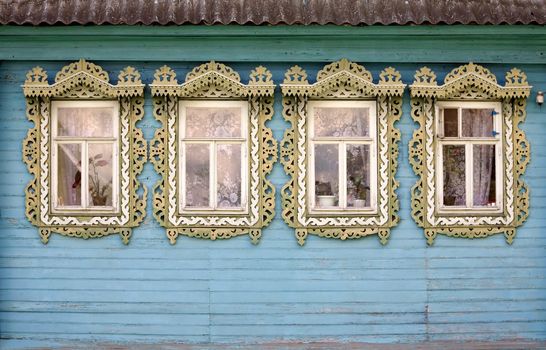 Four windows from old wooden rural wall