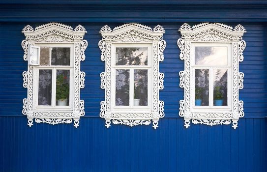 Three windows from old wooden rural wall