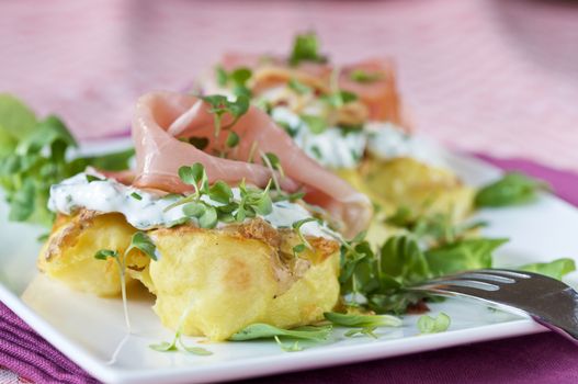 Crispy baked young potatoe with herbal cream cheese and prosciutto ham