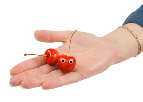 Two sweet cherries on palm on a white background