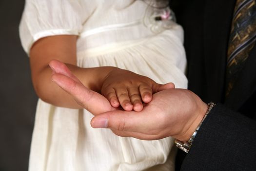 Hand of the adult person and hand of the small child