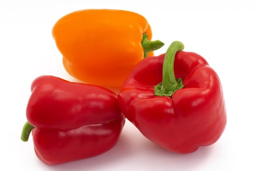 Orange and red pepper on the white background.
