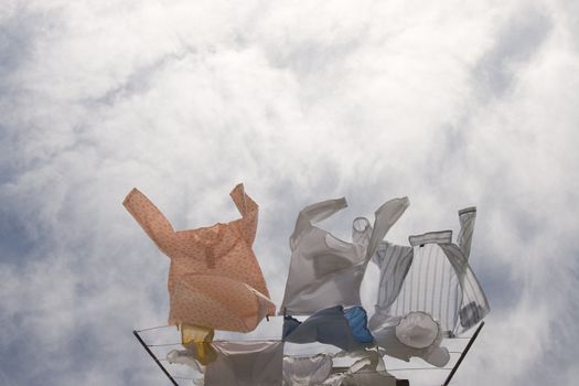 domestic clothes line with wash laundering on sky background