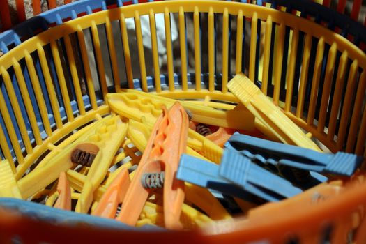 coloured pegs in a plastic basket
