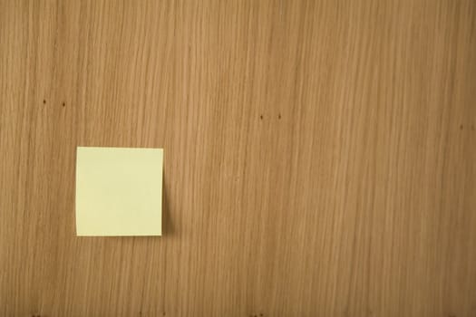 yellow post it on wooden board