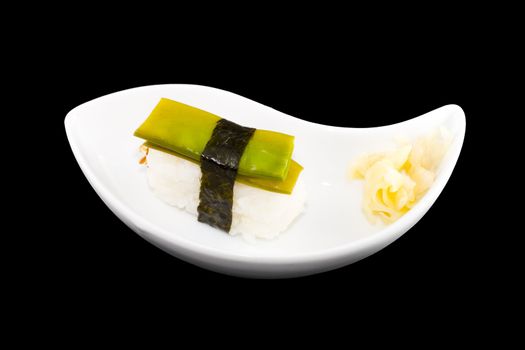 a white plate with a piece of sushi