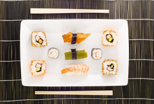 a plate with different kinds of sushi