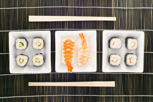 three plates with different kinds of sushi