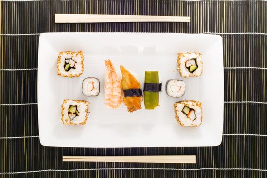 a plate with different kinds of sushi