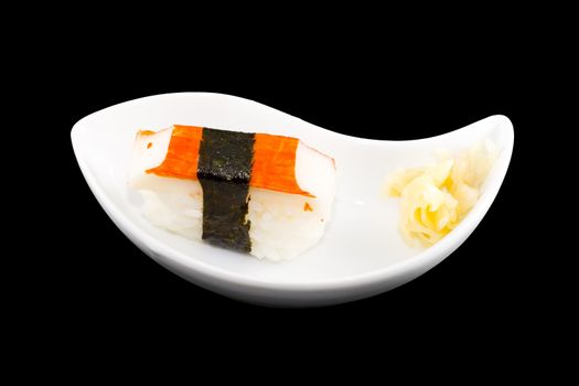 a white plate with a piece of sushi