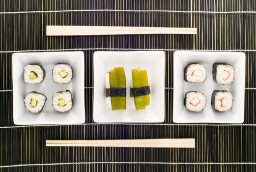 three plates with different kinds of sushi