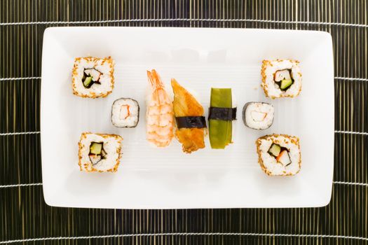 a plate with different kinds of sushi