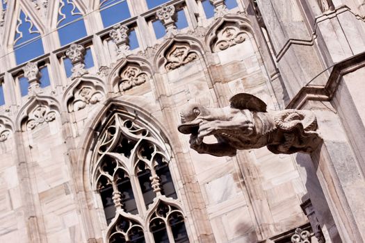 stone statue on the cupola of Milan's cathedral
