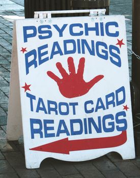 Psychic Readings and Tarot Card Readings Sandwich Board on a brick sidewalk