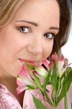 Portrait of young attractive girl with fresh flowers