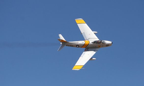 An air force jet executes a turn at an airshow